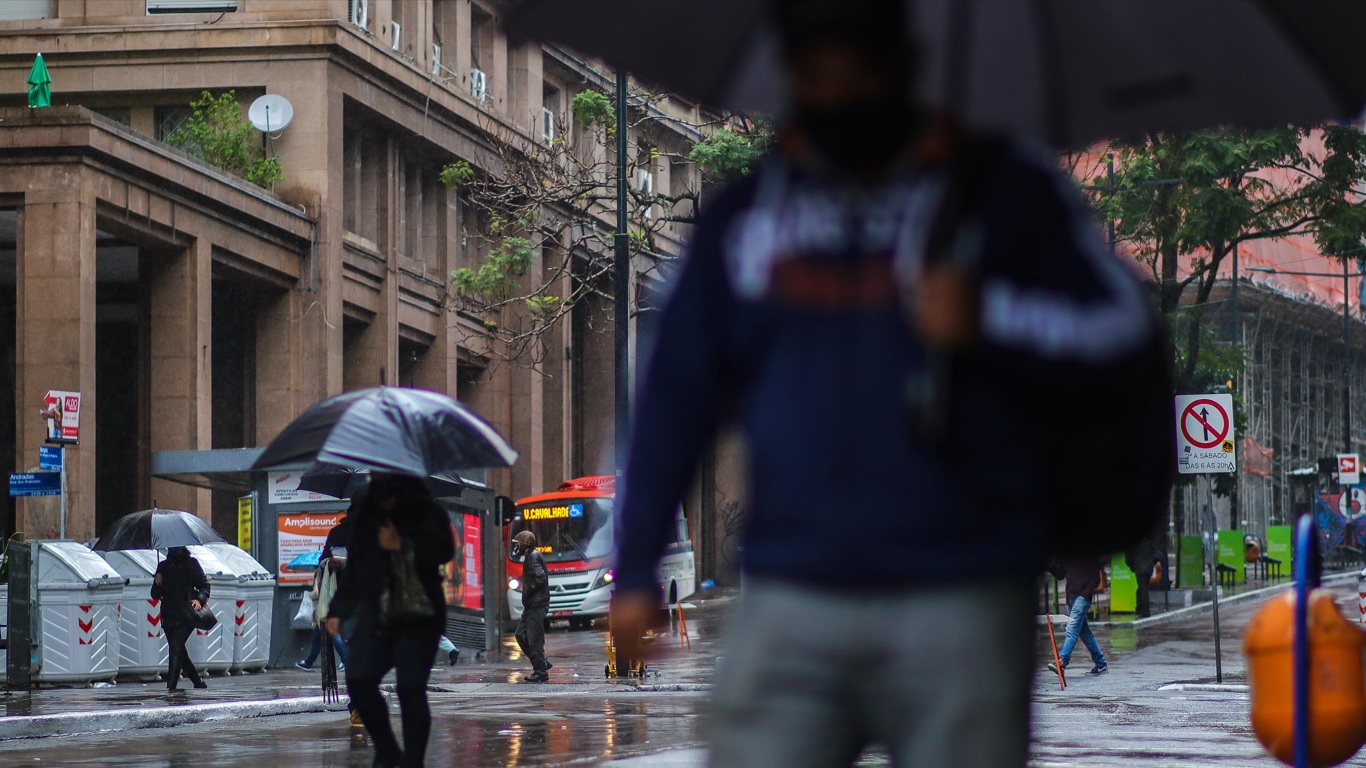 Pessoas com guarda-chuva em Porto Alegre Foto mostra pessoas com guarda-chuva na Avenida Borges de Medeiros em Porto Aegre em dia de chuva na cidade